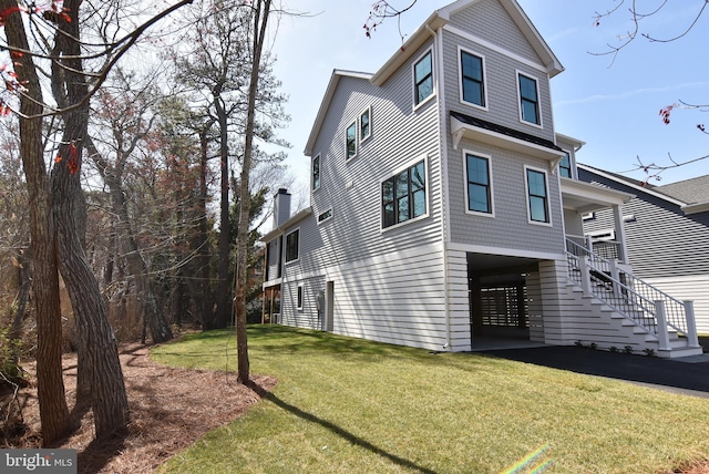 20682 Maple St, Rehoboth Beach, DE 19971 - view of home's exterior with a carport, stairs, and a yard