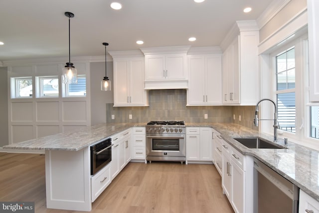 20682 Maple St, Rehoboth Beach, DE 19971 - kitchen with appliances with stainless steel finishes, a peninsula, white cabinets, healthy amount of natural light, and recessed lighting