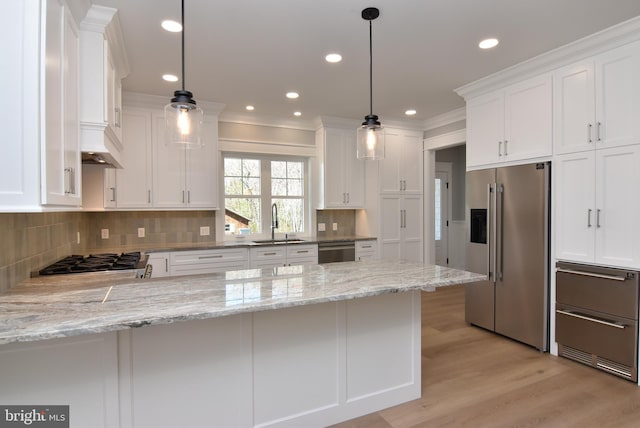 20682 Maple St, Rehoboth Beach, DE 19971 - kitchen featuring appliances with stainless steel finishes, white cabinetry, a peninsula, crown molding, and recessed lighting