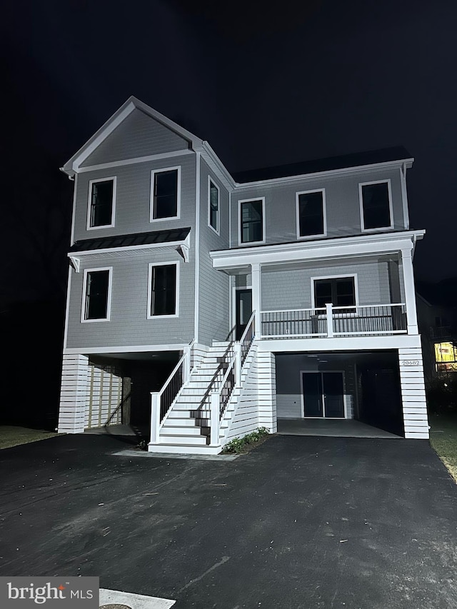 20682 Maple St, Rehoboth Beach, DE 19971 - raised beach house with driveway, stairs, and a carport