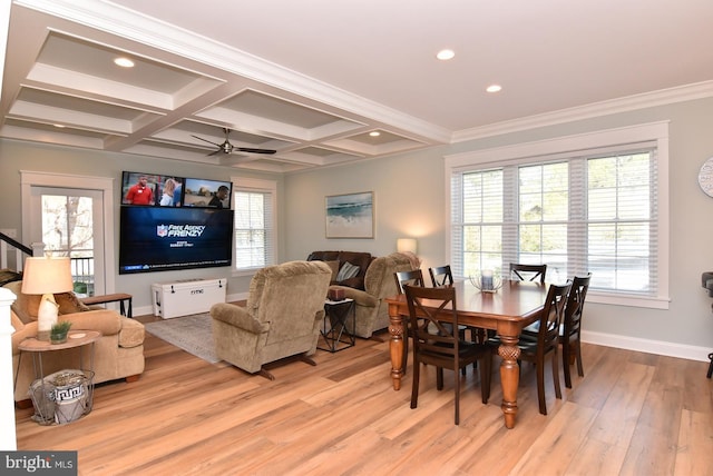 dining room featuring ceiling fan, light wood-type flooring, ornamental molding, and a wealth of natural light