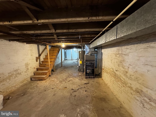 basement featuring heating unit and gas water heater