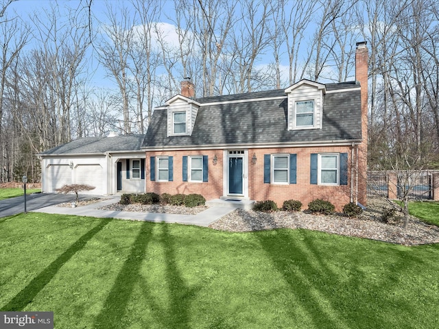 view of front of house featuring a front lawn, brick siding, a chimney, and fence