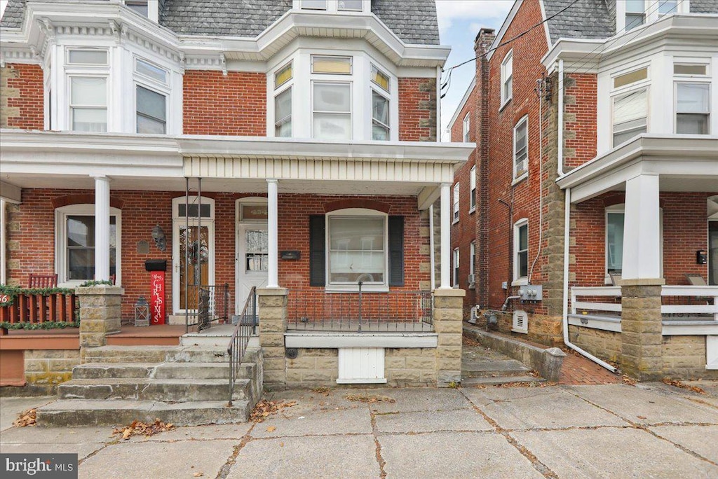 view of property featuring covered porch