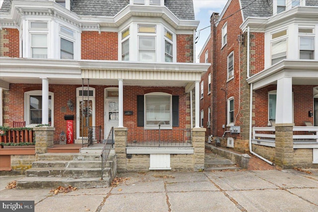 view of property featuring covered porch