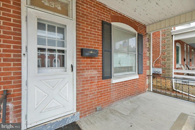 doorway to property featuring covered porch