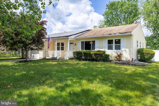 ranch-style home with solar panels, a porch, and a front lawn