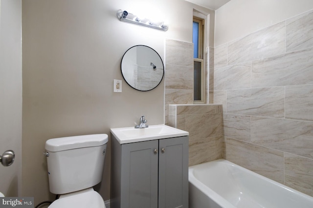 full bathroom featuring vanity, tiled shower / bath combo, and toilet