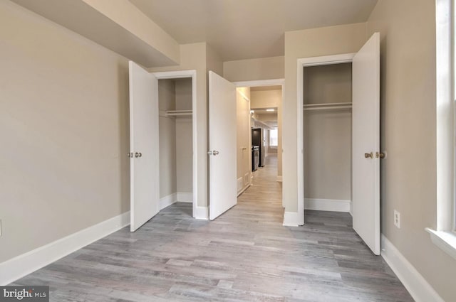 unfurnished bedroom with light wood-type flooring