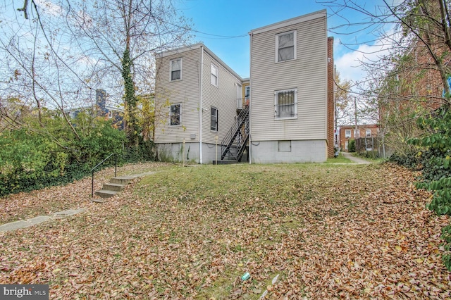 rear view of property with a lawn