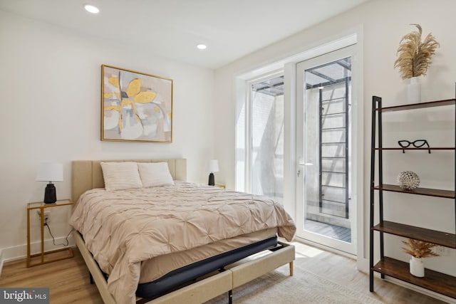 bedroom with hardwood / wood-style flooring and access to exterior