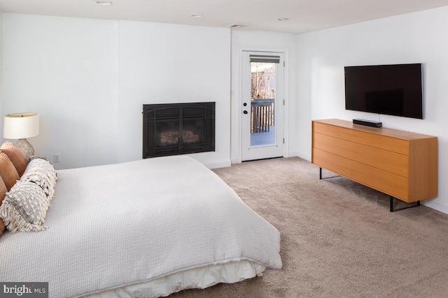 bedroom featuring access to outside and light colored carpet