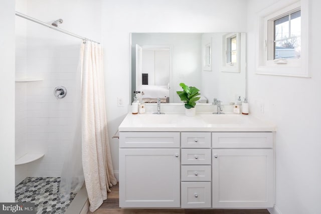 bathroom featuring vanity and curtained shower