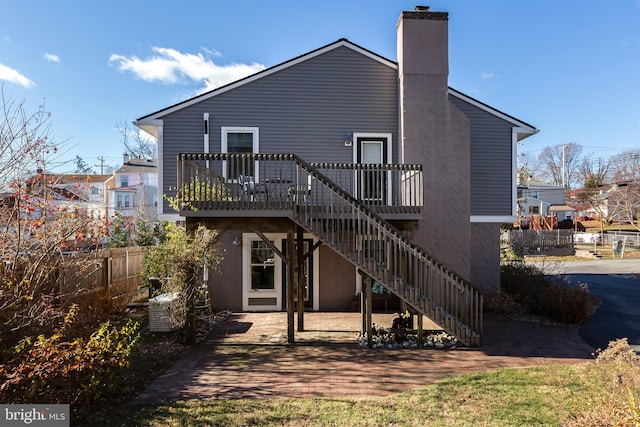 rear view of house with a patio and a deck