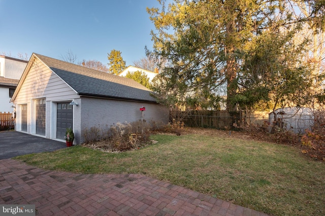 view of home's exterior with a garage and a lawn