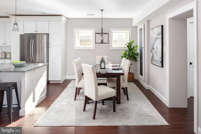 dining area with dark hardwood / wood-style floors