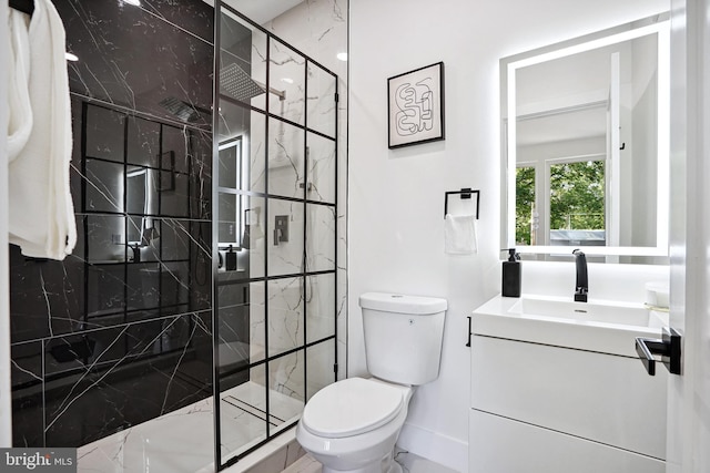 bathroom featuring vanity, a shower with shower door, and toilet