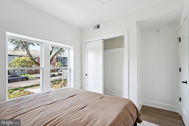 bedroom with hardwood / wood-style flooring and a closet