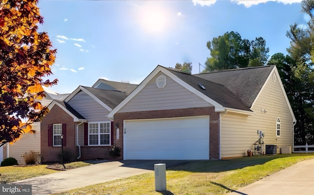 view of front facade with cooling unit, a garage, and a front lawn