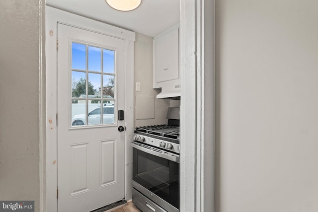 kitchen featuring range hood and gas range