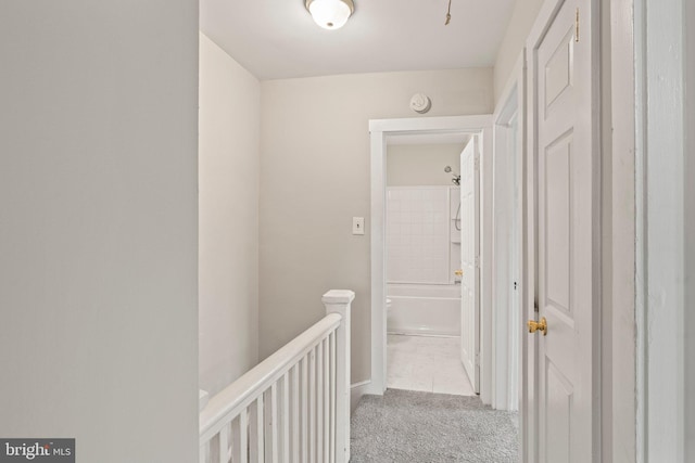 hall featuring light colored carpet