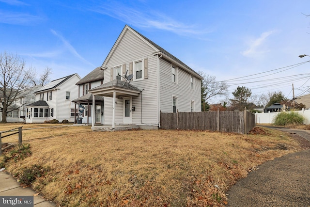 view of property with a front yard and a porch