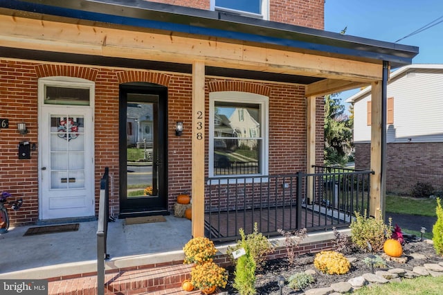 property entrance with covered porch