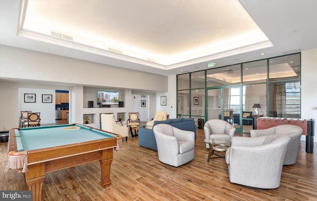 playroom featuring a raised ceiling, hardwood / wood-style flooring, and billiards