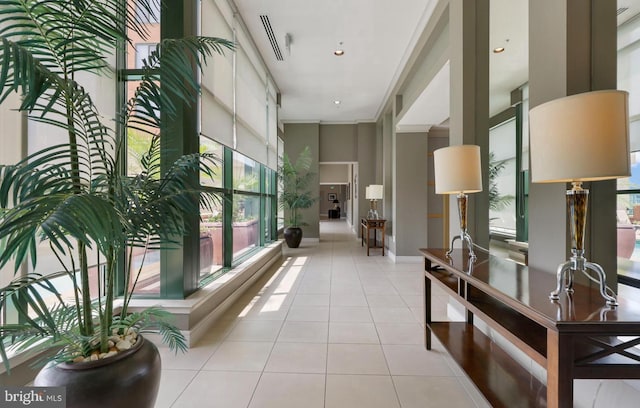 corridor featuring crown molding and light tile patterned floors