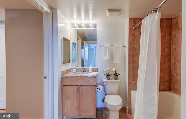 full bathroom featuring tile patterned flooring, shower / tub combo with curtain, vanity, and toilet