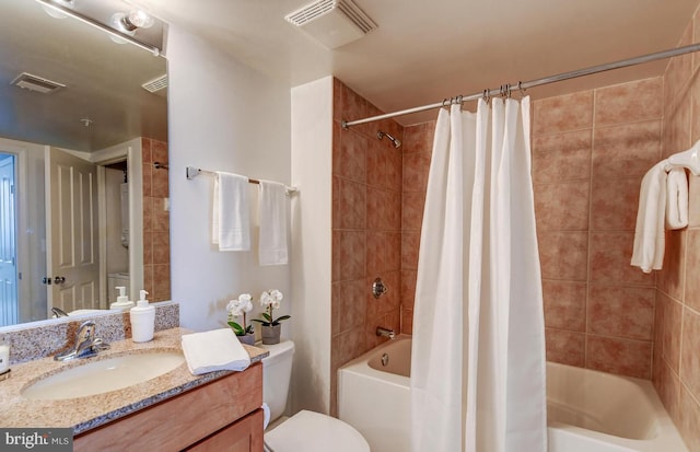 full bathroom featuring shower / bath combo, vanity, and toilet