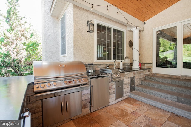 view of patio featuring exterior kitchen and grilling area