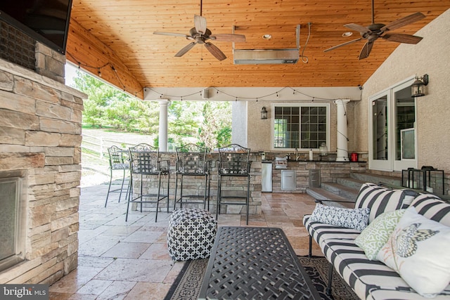 view of patio featuring an outdoor bar and ceiling fan