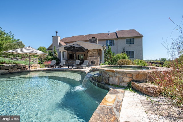 view of pool featuring an in ground hot tub and a patio