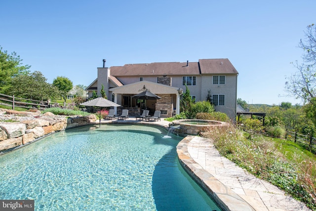 view of swimming pool featuring an in ground hot tub, a patio, and pool water feature