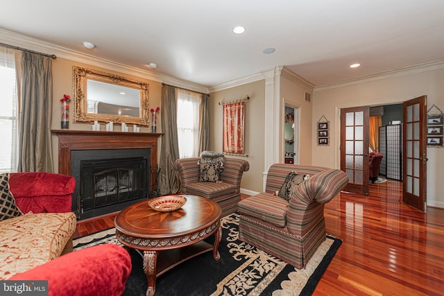 living room featuring wood-type flooring and ornamental molding