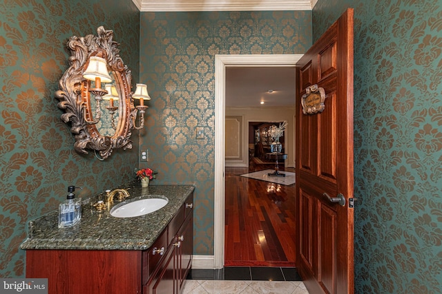 bathroom featuring tile patterned floors, ornamental molding, and vanity