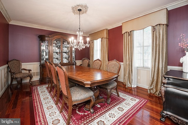 dining area with crown molding, an inviting chandelier, and dark hardwood / wood-style floors