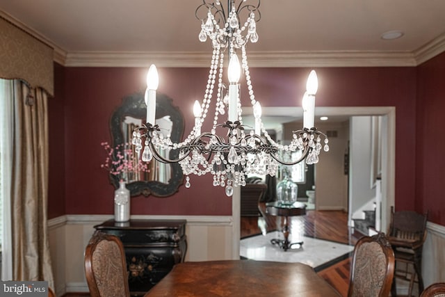 dining area featuring hardwood / wood-style floors and crown molding