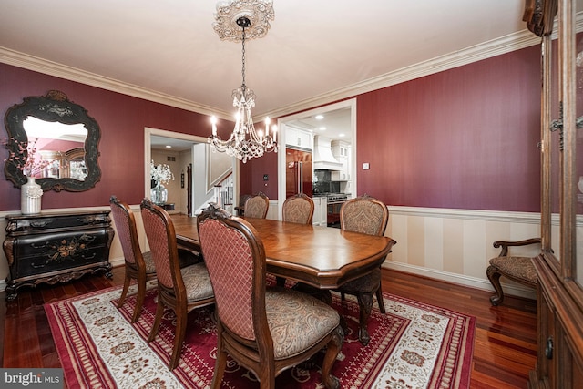 dining area with crown molding, an inviting chandelier, and dark hardwood / wood-style flooring