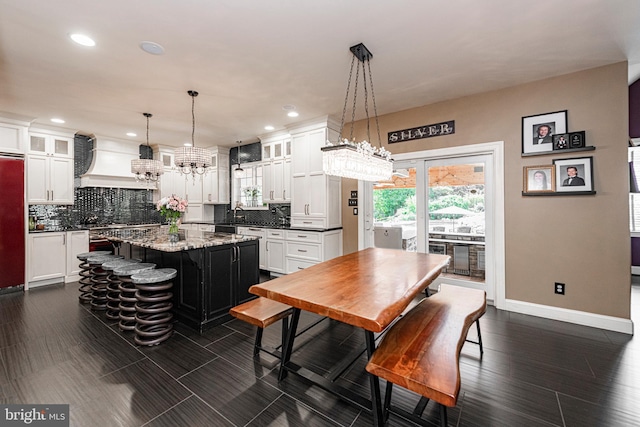 dining room featuring dark hardwood / wood-style flooring and a notable chandelier