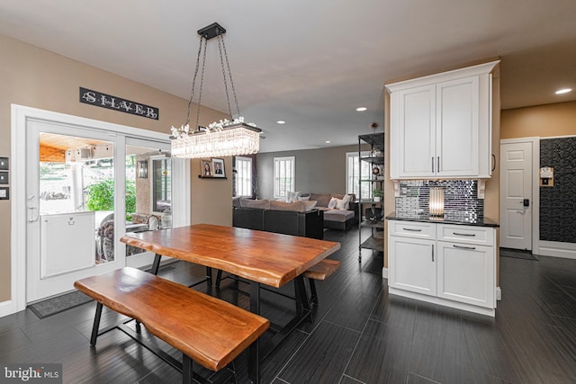 dining room featuring a healthy amount of sunlight and dark hardwood / wood-style flooring