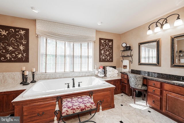 bathroom featuring tile patterned floors, a bathing tub, and vanity