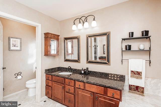 bathroom with toilet and vanity