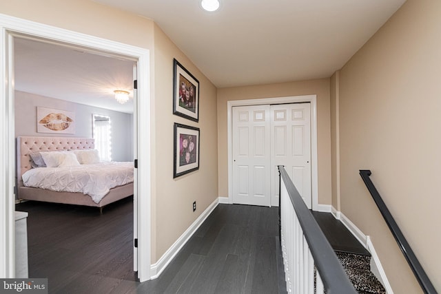 hallway with dark hardwood / wood-style flooring