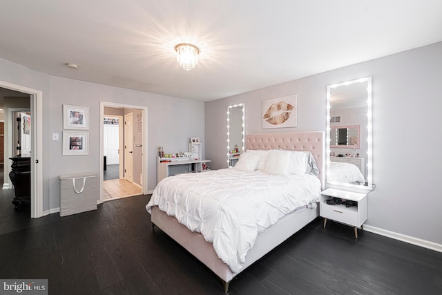 bedroom with dark hardwood / wood-style floors