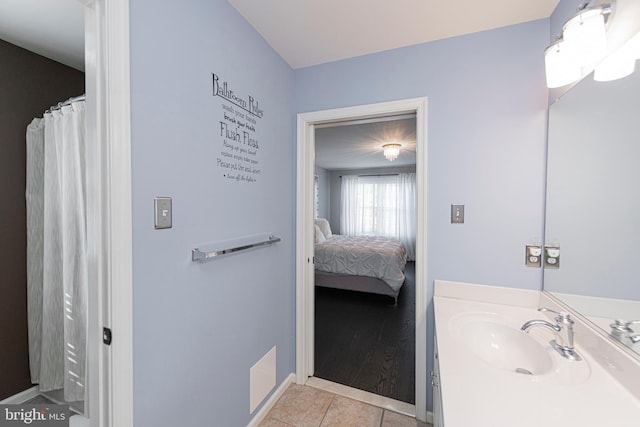 bathroom with vanity, tile patterned flooring, and walk in shower