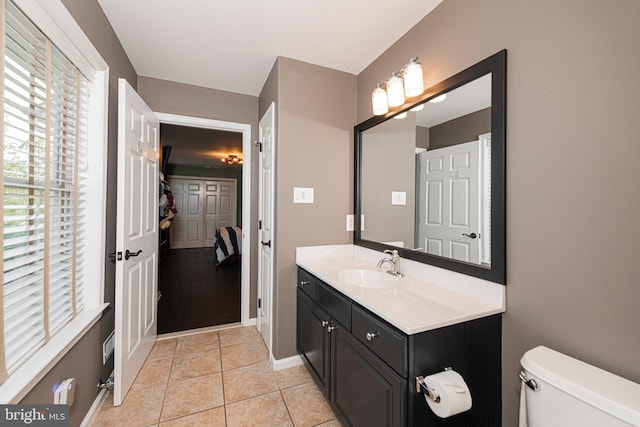 bathroom featuring tile patterned flooring, vanity, and toilet