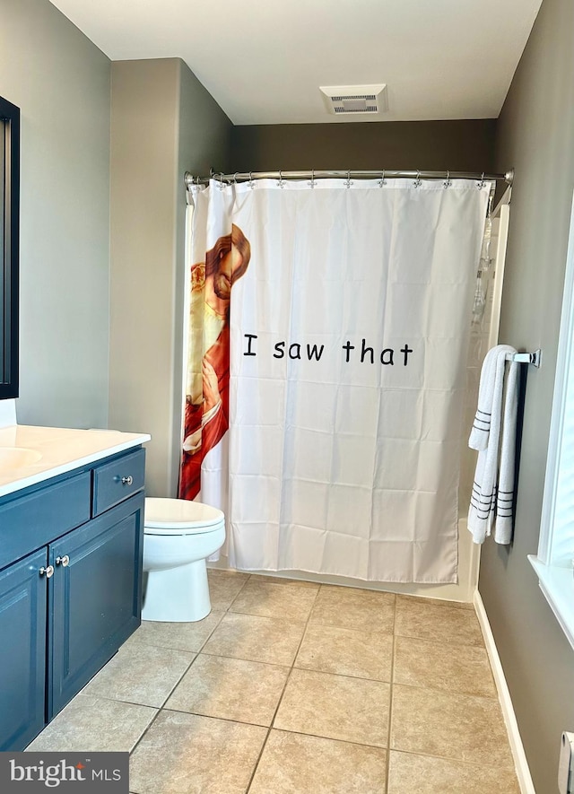 bathroom with a baseboard radiator, toilet, vanity, and tile patterned flooring