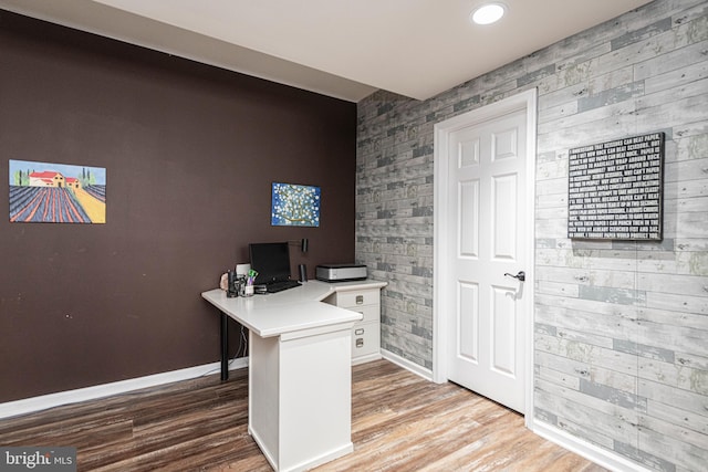 home office with light hardwood / wood-style floors